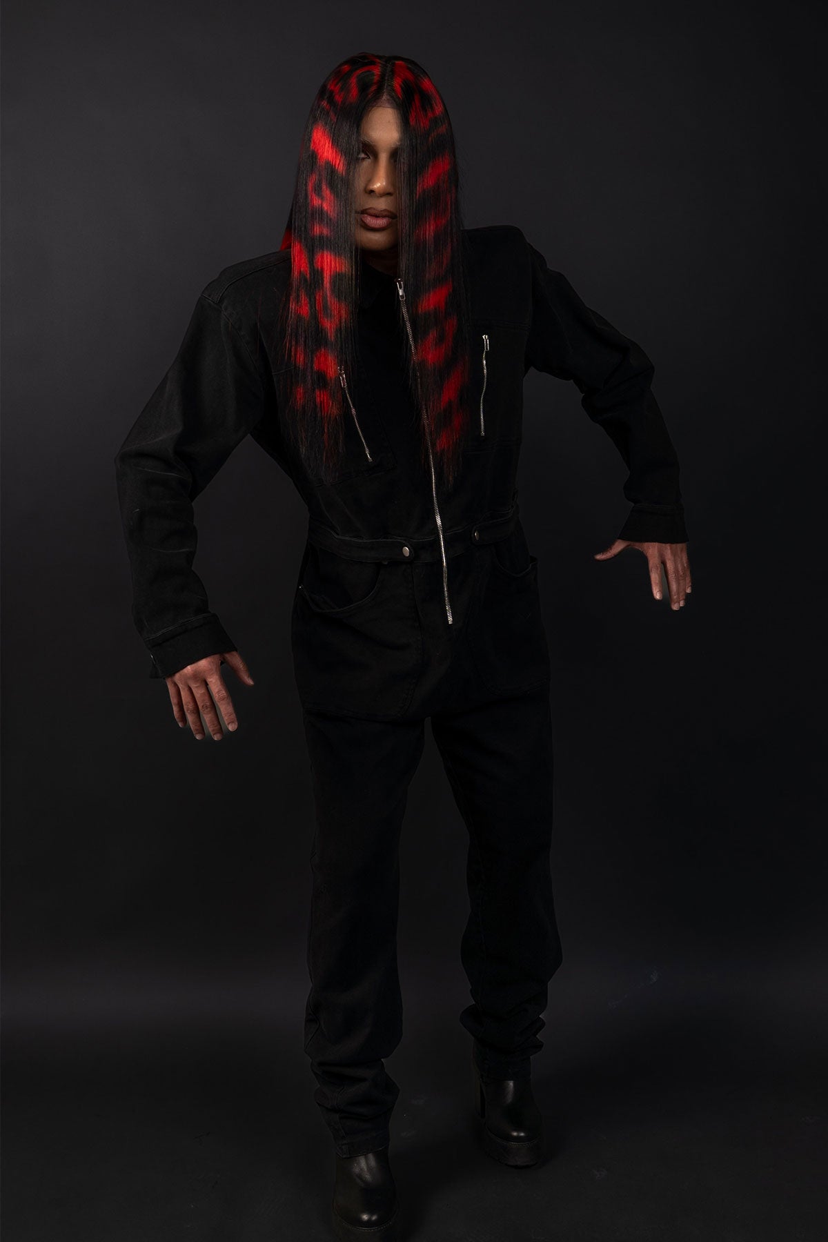 a full body photo of a model wearing black in a black and red skull wig