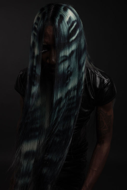 a front view of a model wearing a blue black and white ghost face wig