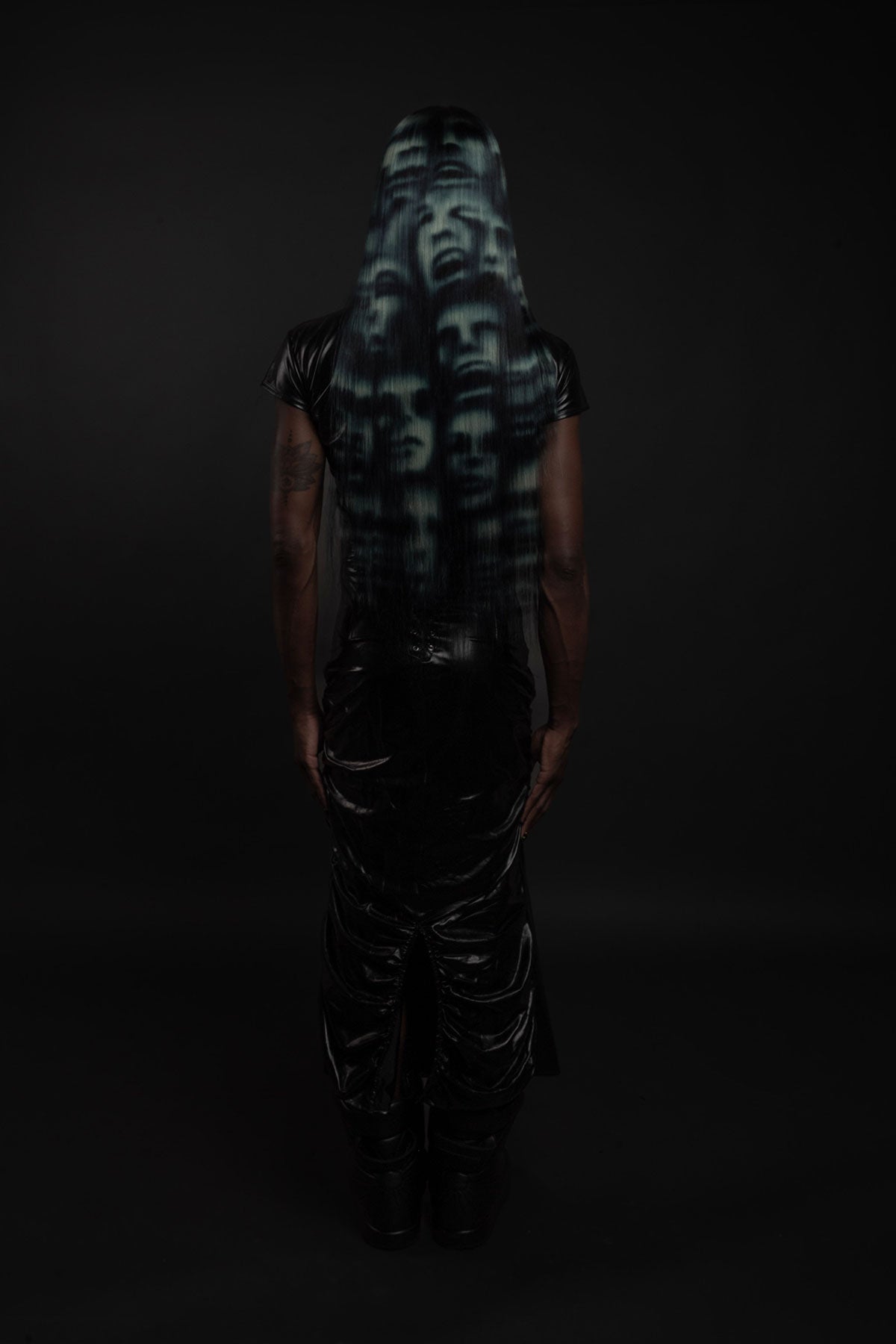 a back view of a model wearing a blue black and white ghost face wig