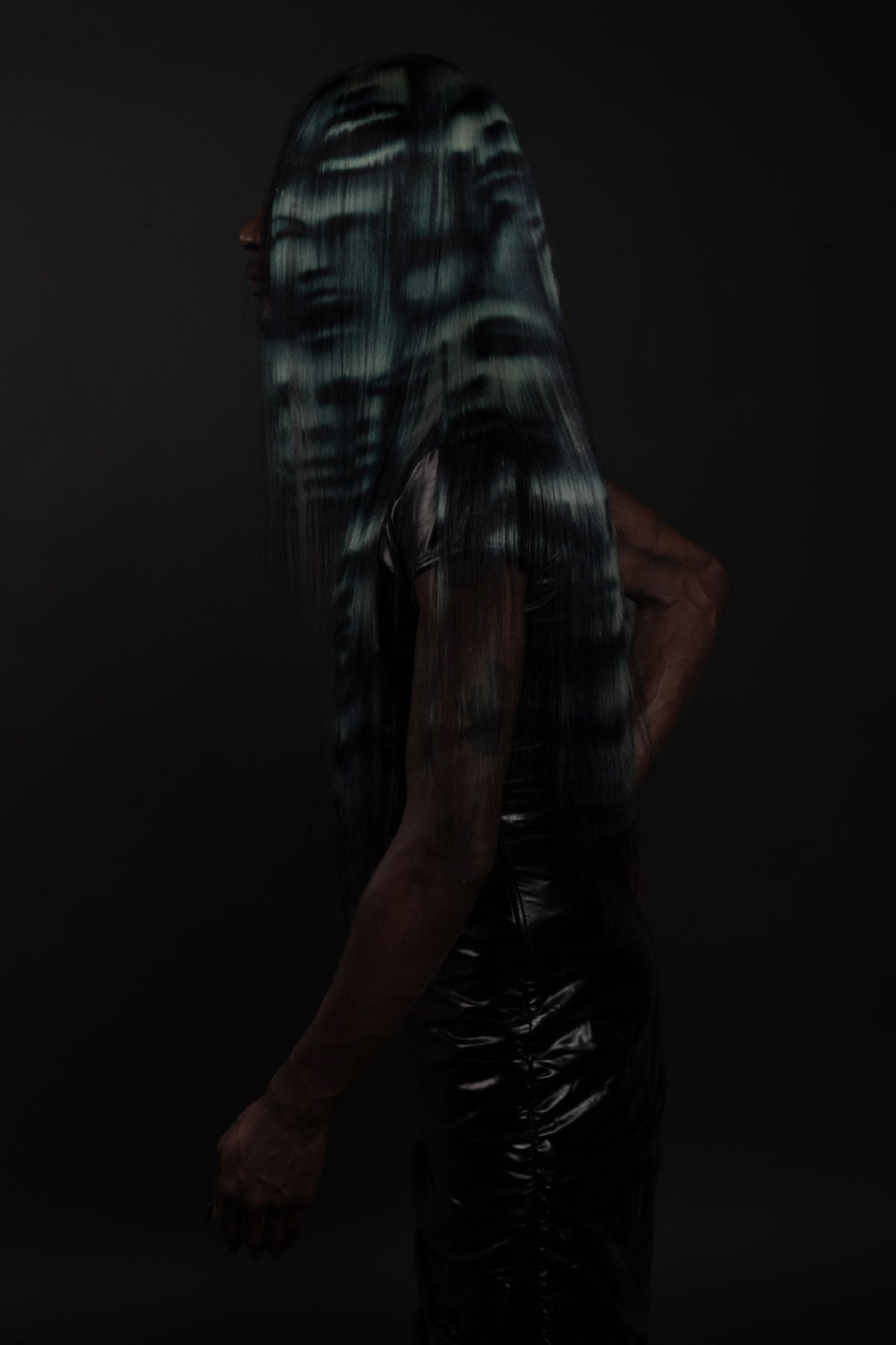 a side view of a model wearing a blue black and white ghost face wig