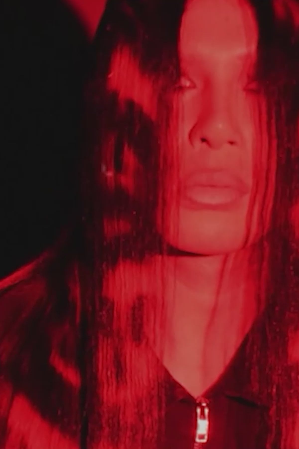 multiple shots of red lighting and a model wearing black in a black and red skull wig